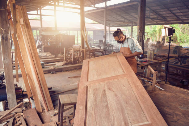 istock Carpenter working on woodworking machines in carpentry shop. 1332621544