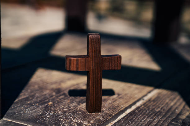 istock An old tree trail and a wooden cross. 1332622527