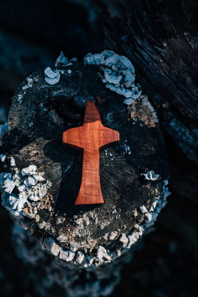 istock An old tree trail and a wooden cross. 1332622699