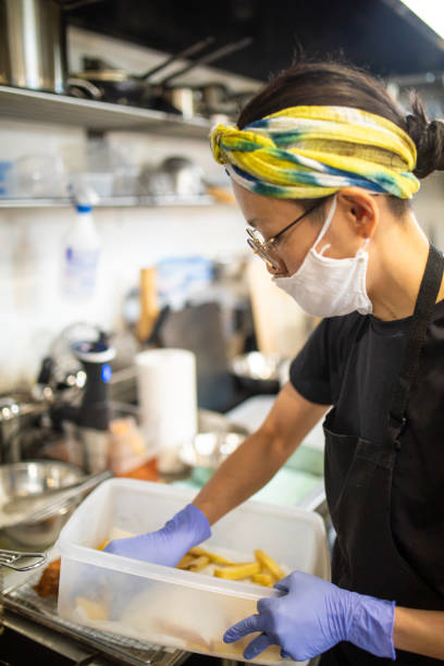 istock Female chef preparing food in her cafe kitchen 1332623043