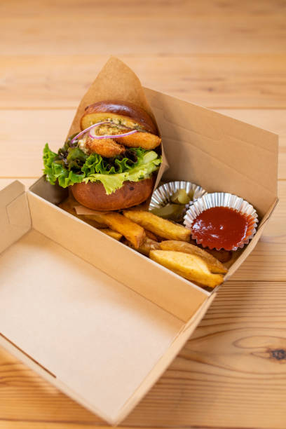 istock Fresh made take away hamburger with onion rings in a take away box 1332623065