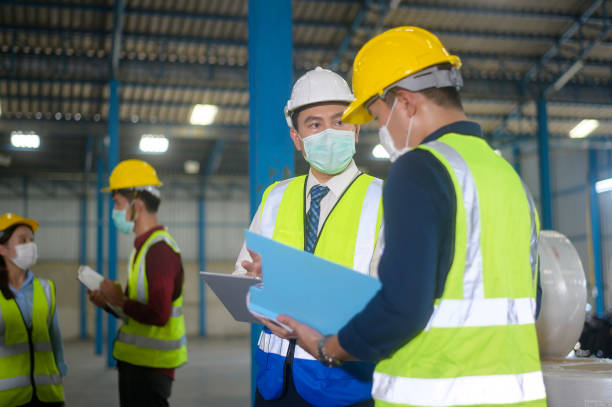 istock Engineer people are wearing  protective mask working in warehouse 1332625626