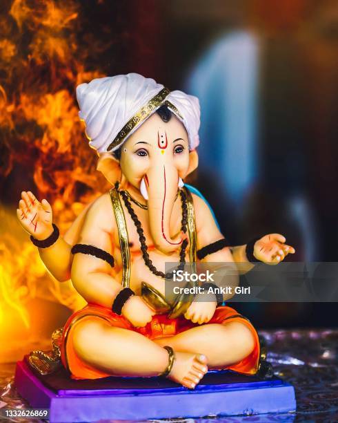 Lord Ganesha Closeup Shot With Yellow Lights In Background Stock Photo -  Download Image Now - iStock