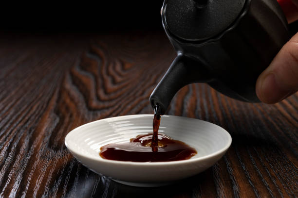 Pour the soy sauce into a small plate Pour the soy sauce into a small plate soia sauce stock pictures, royalty-free photos & images