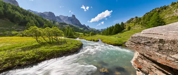La Claree river in Summer with the famous Main de Crepin peak in the Cerces Massif mountain range. Claree Valley (Laval) in Hautes Alpes (05), Southern French Alps, France