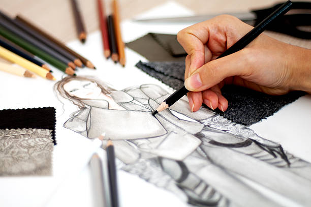 fashion designer Fashion designer is drawing an artistic fashion sketch ,close-up photo fashion designer photos stock pictures, royalty-free photos & images