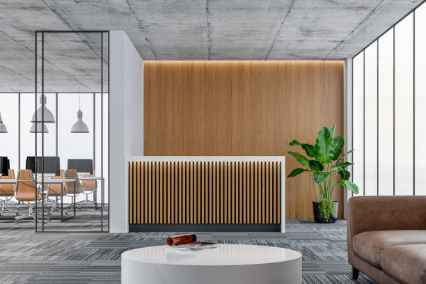 istock Large office interior: a reception desk, a lounge corner with copy space and wordesks behind glass door 1332631240