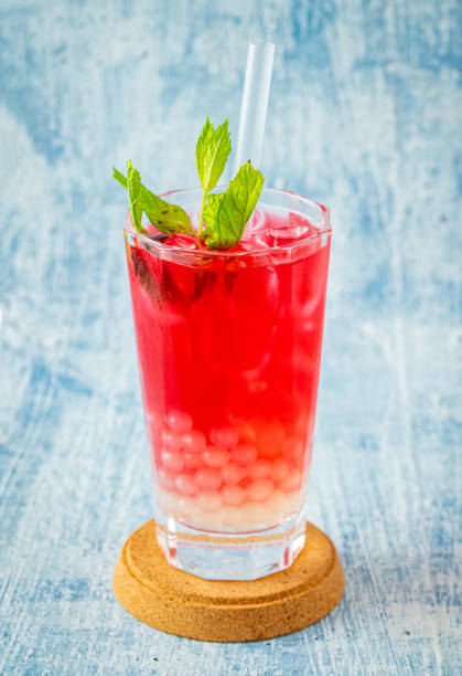 istock Fruity Bubble Tea in glass cup on blue background 1332631459