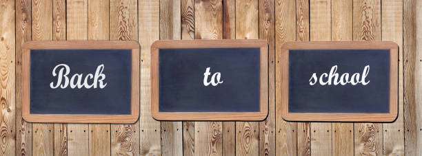 Back to school written on three late on wooden panel