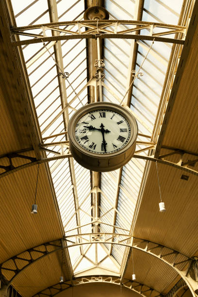 istock Vintage clock with Roman numerals under the glass arched ceiling 1332633721