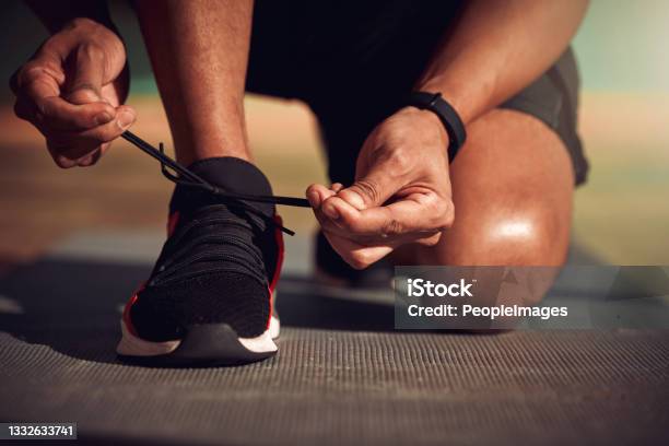 Shot Of A Man Tying His Laces Before Running Stock Photo - Download Image Now - Shoe, Getting Dressed, Sports Shoe