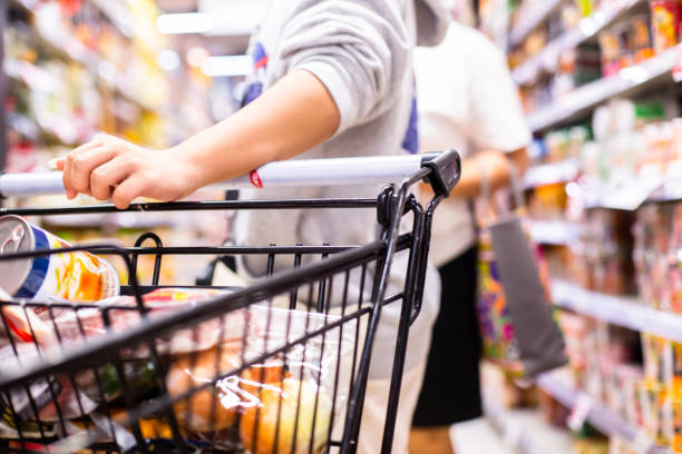 istock Selective focus to Customer's hand is pushing a shopping cart 1332634773