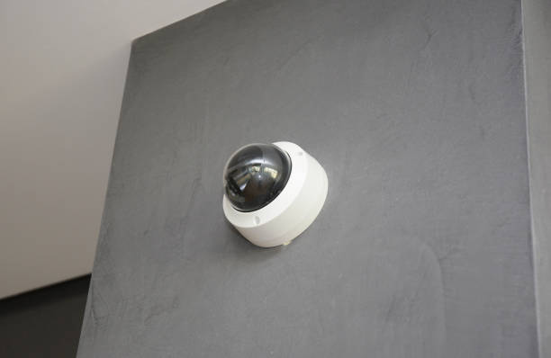 istock A close-up of a round security camera, security surveillance installed on a gray plastered wall inside a modern apartment. 1332636665