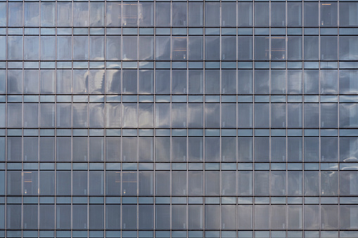 Close-up of the glass windows of city buildings, background