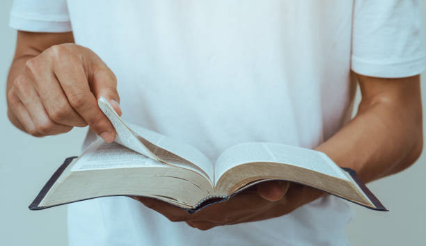 close up young man reading the holy bible. close up young man reading the holy bible. christian social union photos stock pictures, royalty-free photos & images