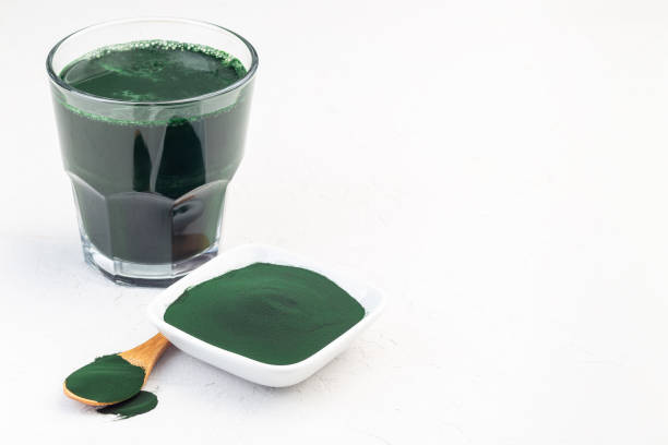 istock Superfood chlorella in powder and as drink, on white background, horizontal, copy space 1332637994