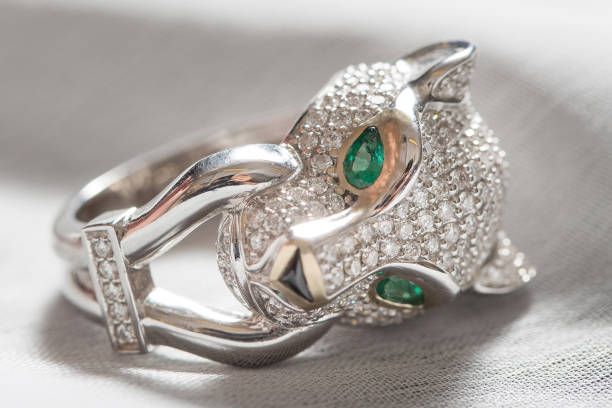 istock white gold diamond ring tiger head with green gem 1332638811