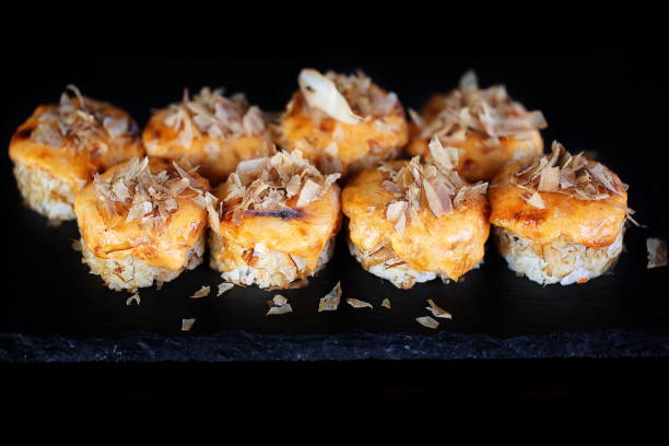 istock Rolls with red caviar on a black background 1332641686