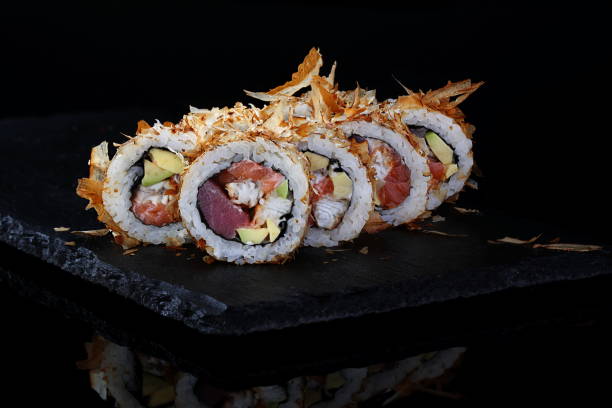 istock Rolls with red caviar on a black background 1332641688