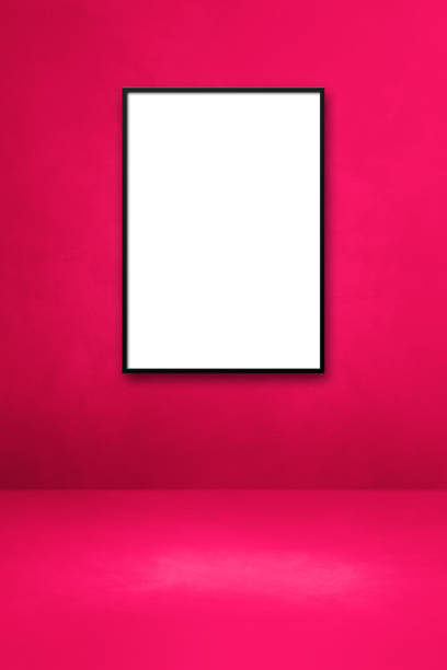 istock Black picture frame hanging on a pink wall 1332643679