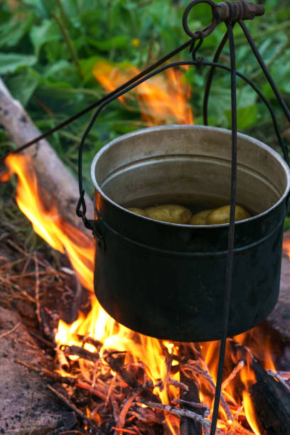 istock Dixie with potatoes stands on the fire, close-up photo 1332643694