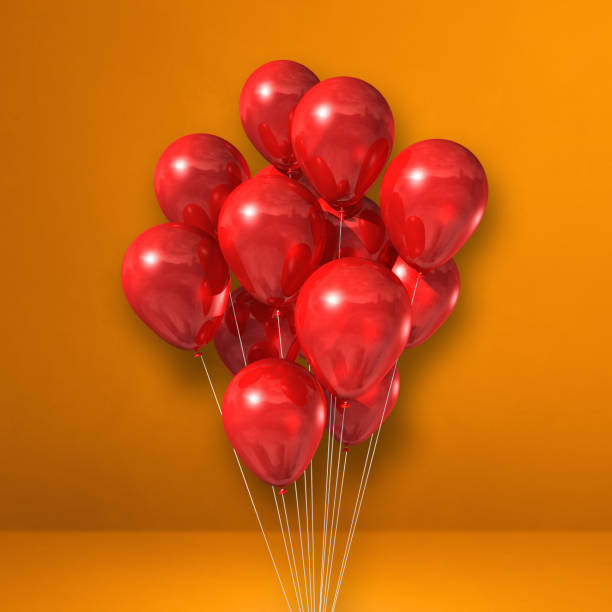 istock Red balloons bunch on orange wall background 1332643937