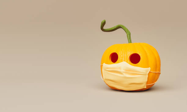 istock halloween pumpkin with medical mask 1332647723