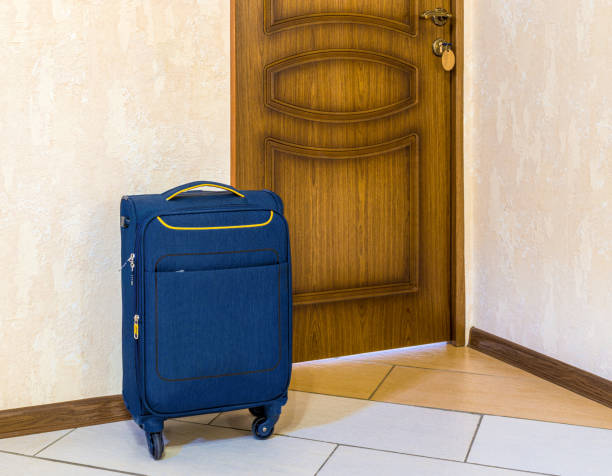 istock Suitcase is near door 1332649280