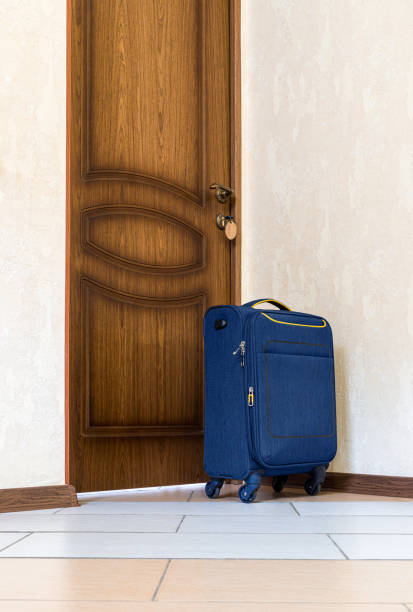 istock Suitcase is near door 1332649290