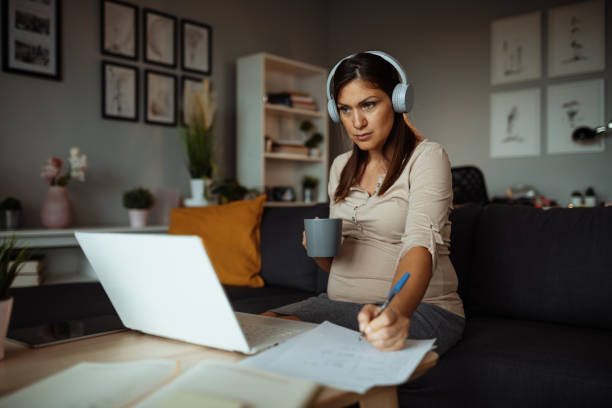 istock Pregnant businesswoman working at home, having video call while working remotely 1332650497