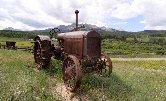 Antique farm equipment in front of Mt. Wilson in the Uncompahgre National Forest of Colorado