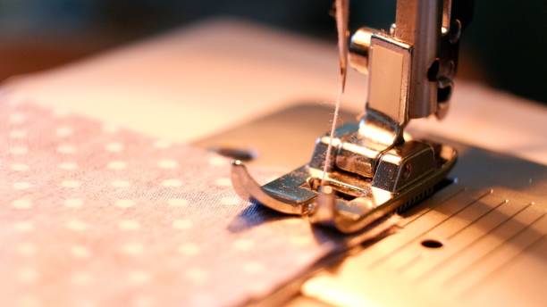 Sewing machine on blurred background, macro view. Space for text