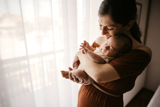 istock Mother holding her newborn son 1332654399