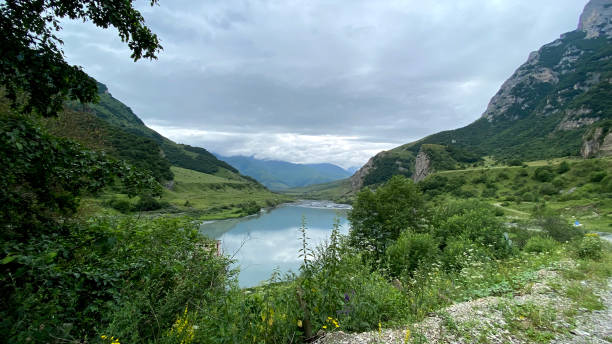 istock A small lake surrounded by impenetrable rocks and majestic mountains. 1332654404