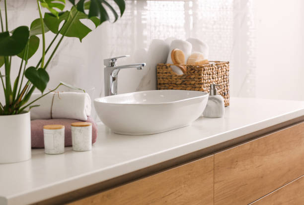 istock Stylish vessel sink on light countertop in modern bathroom 1332654696