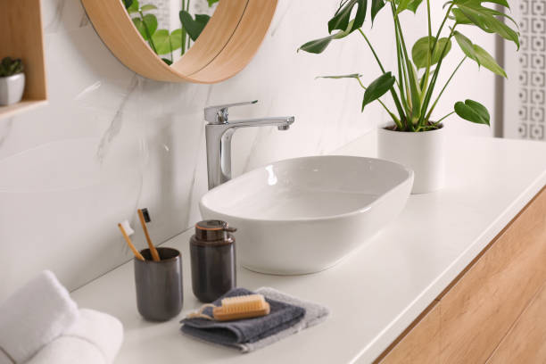 istock Stylish vessel sink on light countertop in modern bathroom 1332654775