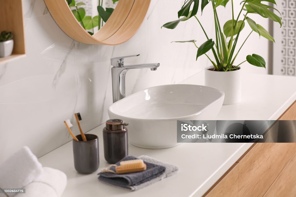 Stylish vessel sink on light countertop in modern bathroom Bathroom Stock Photo