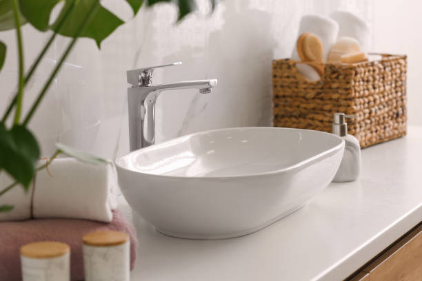 istock Stylish vessel sink on light countertop in modern bathroom 1332654835