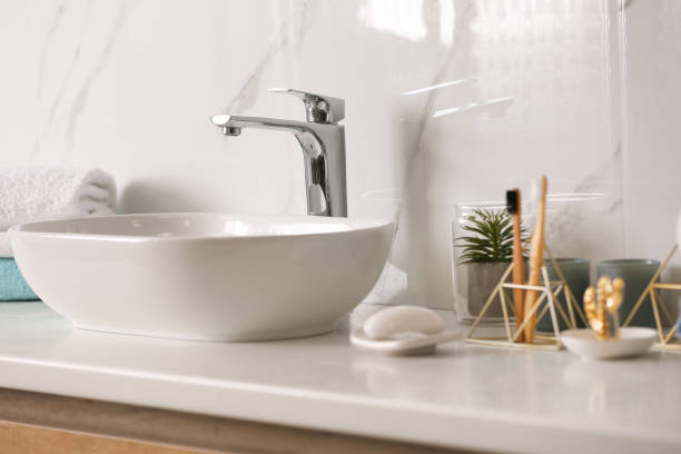 istock Stylish vessel sink on light countertop in modern bathroom 1332654864