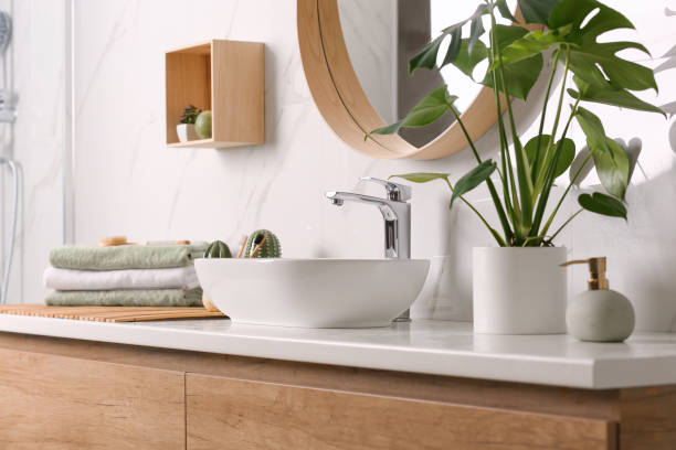 istock Stylish vessel sink on light countertop in modern bathroom 1332654918