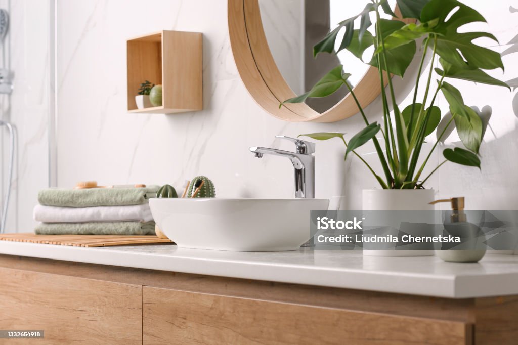 Stylish vessel sink on light countertop in modern bathroom Bathroom Stock Photo