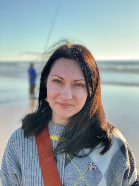 istock Young millennial woman by the ocean. 1332654979