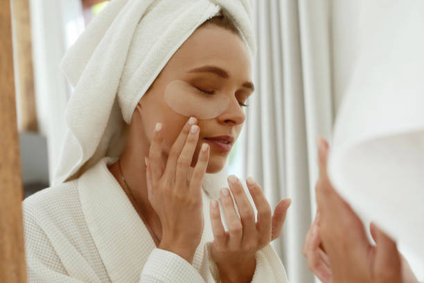 istock European girl applying under eye patch on face 1332654996