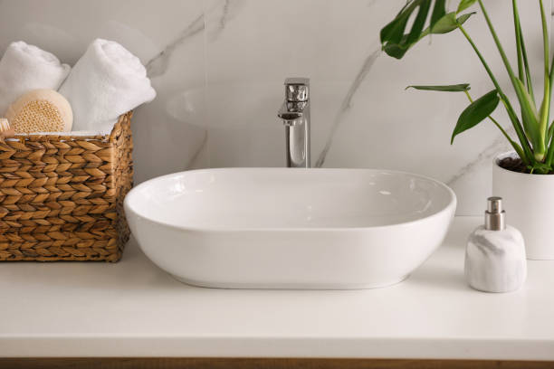 istock Stylish vessel sink on light countertop in modern bathroom 1332655037