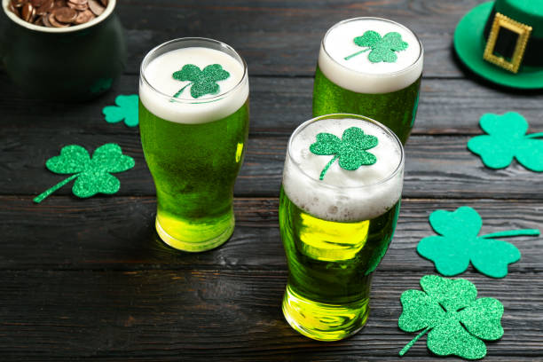 Green beer and clover leaves on black wooden table. St. Patrick's Day celebration Green beer and clover leaves on black wooden table. St. Patrick's Day celebration st. patricks day photos stock pictures, royalty-free photos & images