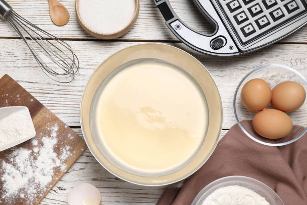 istock Flat lay composition with ingredients for cooking Belgian waffles on white wooden table 1332655156