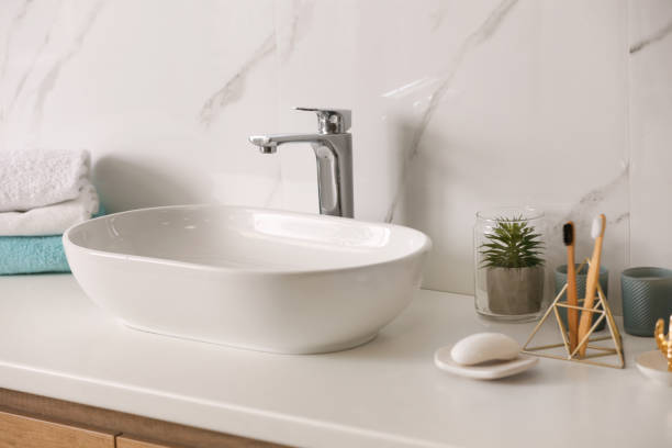 istock Stylish vessel sink on light countertop in modern bathroom 1332655176