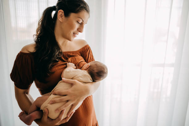 Mother breastfeeding her newborn son