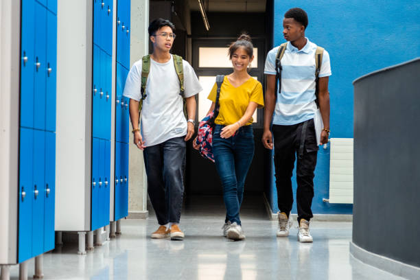 Group of teen high school students changing classes walking in school corridor. Back to school. Group of teen high school students changing classes walking in school corridor. Back to school. Education concept. high school student stock pictures, royalty-free photos & images