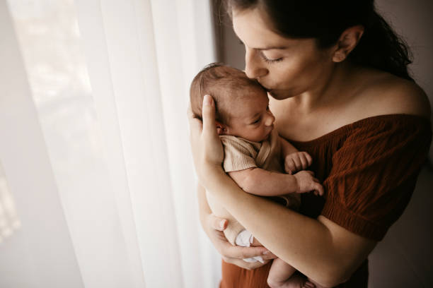 istock Mother holding her newborn son 1332658068